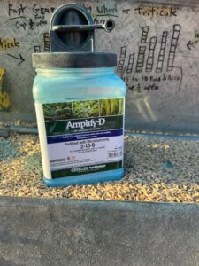 Container of Amplify-D setting in seed in a grain drill