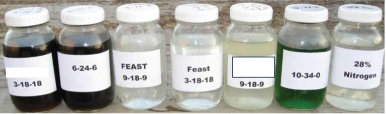 Sample bottles of various liquid fertilizers showing clarity and color