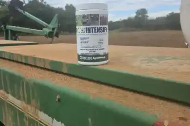 container of Intensify plant growth regulator sitting on a grain drill