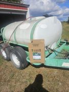a 2.5 gallon twin pack of Wex stitting on the tongue of a pasture sprayer.